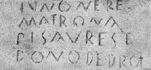 a photo of a now-illegible Roman inscription on stone